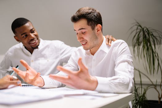 Two colleagues in the office offering support and encouragement during work.